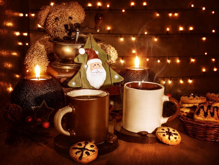 Christmas coffee and cookies with candles and lights