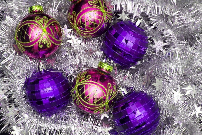 Purple and pink Christmas ornaments with silver tinsel