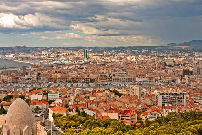Marseille cityscape from above with harbor and clouds