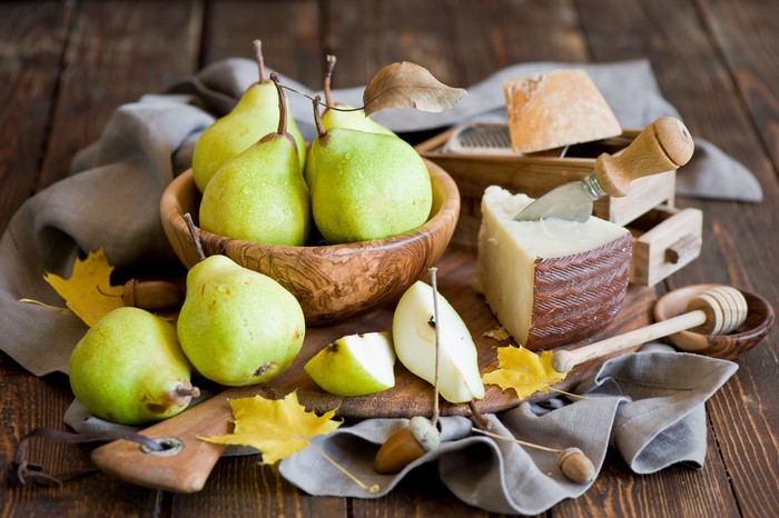 Pears and cheese on a wooden table