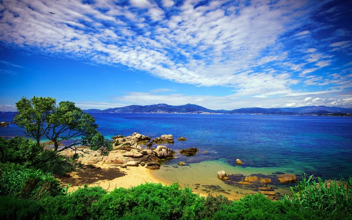 Coastline with rocky beach and distant mountains