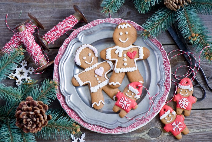 Christmas gingerbread cookies on a plate with pine cones and fir branches