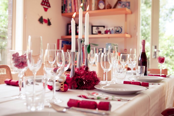 Christmas table setting with candles and wine