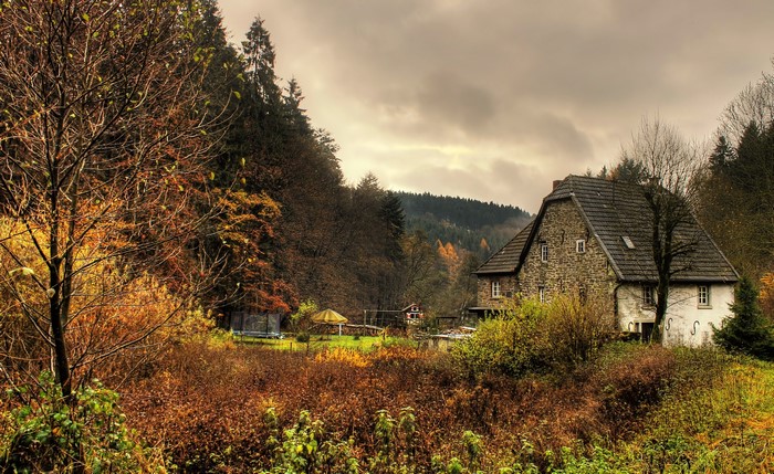 Stone house in a forest during autumn in Marienheide, Germany