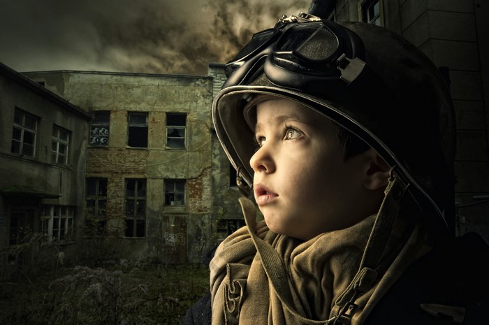 Boy in Helmet and Goggles in War-Torn City