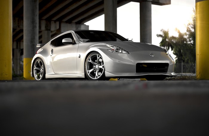Silver Nissan 370Z parked under a bridge