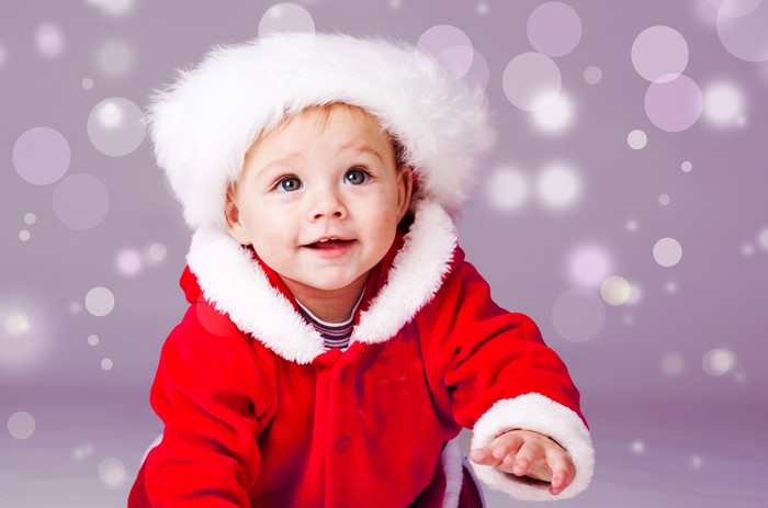 Baby in Santa costume with bokeh background