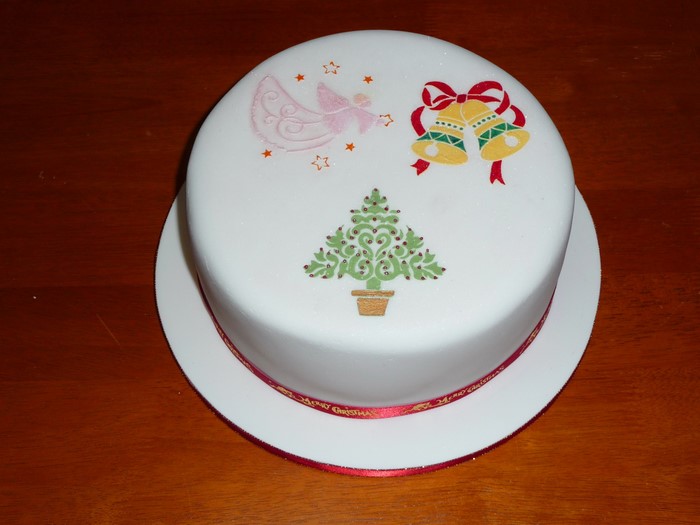 Christmas cake with angel, bells, and tree decorations