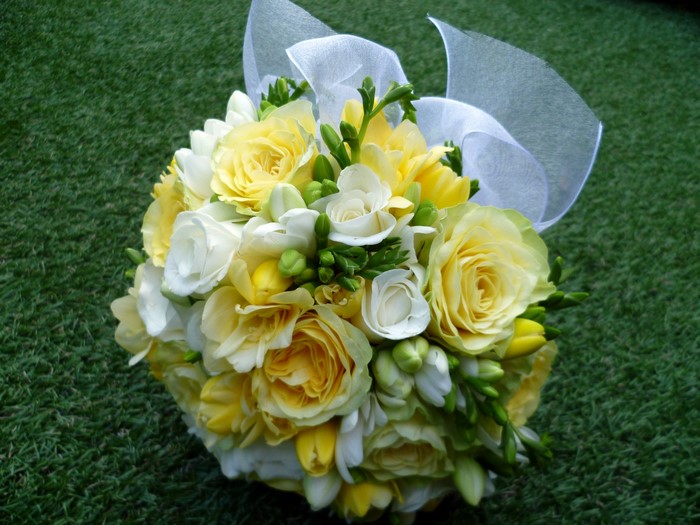 Yellow and white roses and freesia bouquet with ribbon