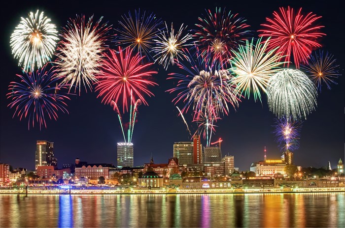 Fireworks over a city skyline at night