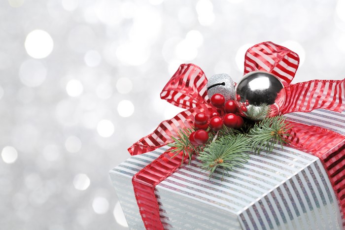 Christmas gift with red ribbon and ornaments