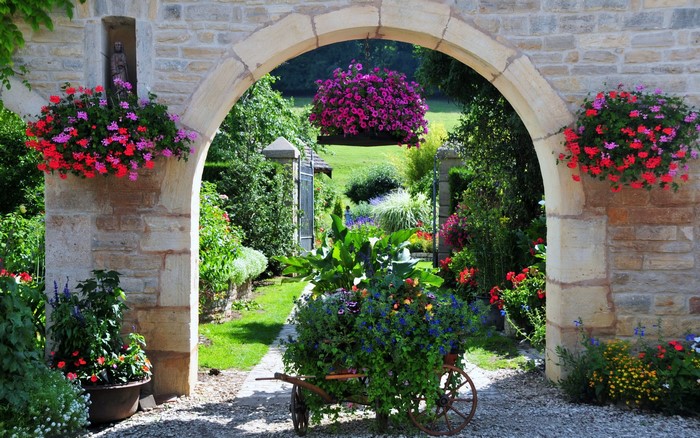 Stone Archway Overlooking a French Garden with Flowers
