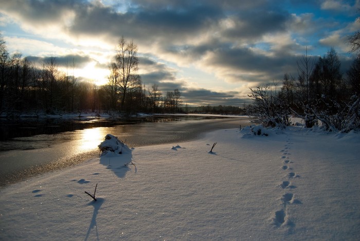 Winter river landscape with snow and sunset