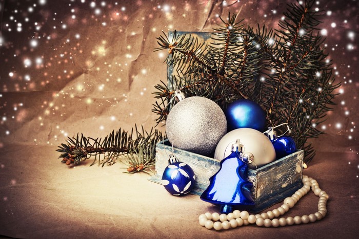 Christmas ornaments in a wooden box with pine branches