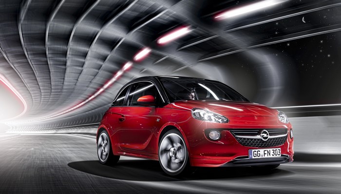 Red Opel Adam driving through a tunnel