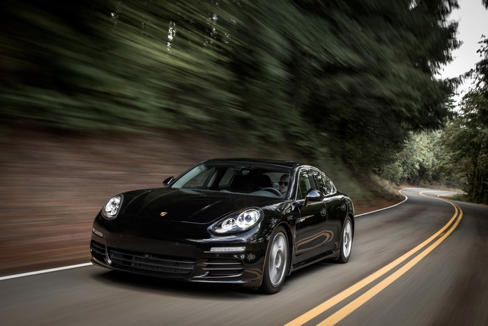 Black 2014 Porsche Panamera S E-Hybrid driving on a road