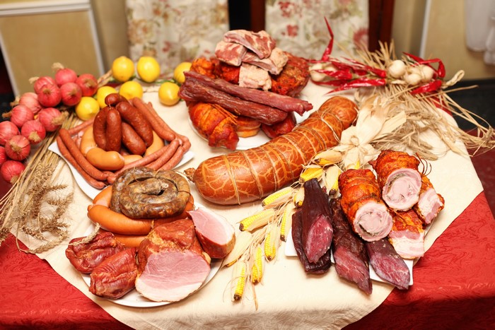 Meat products, sausages, ham, onions, lemons, garlic, still-life