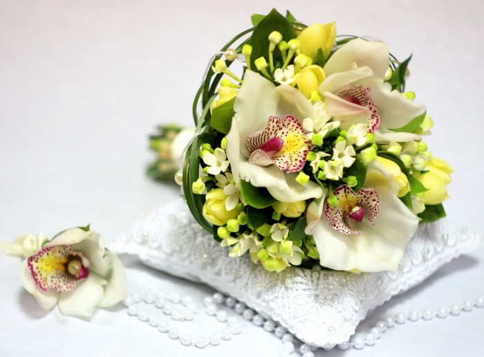 White orchids and yellow tulips wedding bouquet with boutonniere