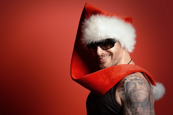 Man in Santa hat and sunglasses with tattoos