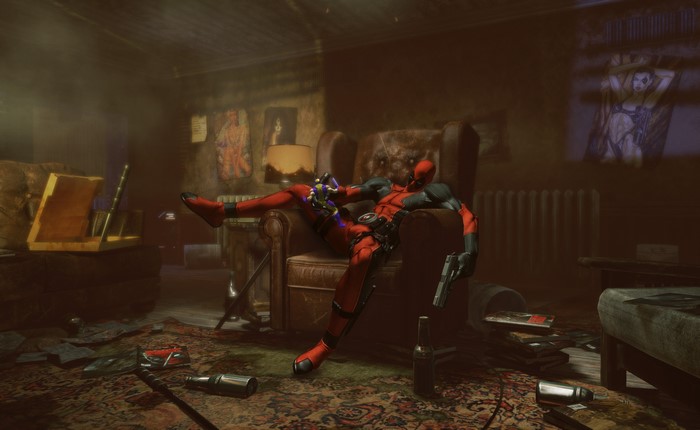 Deadpool sitting in an armchair in a messy room