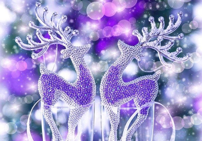 Two Christmas reindeer ornaments with purple glitter