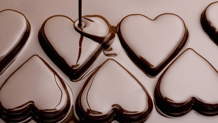 Chocolate being poured into heart-shaped molds