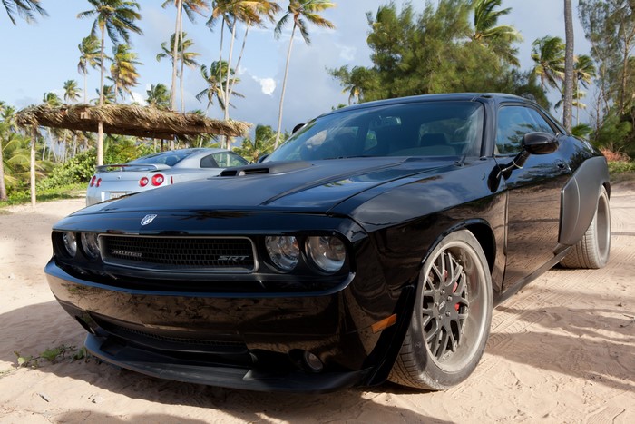 Black Dodge Challenger SRT on a sandy beach