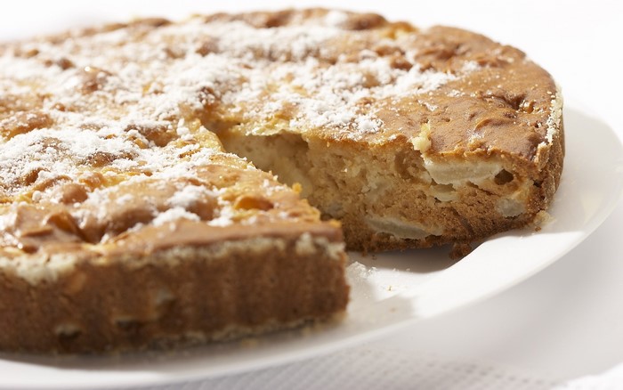 Close-up of a dusted pie on a white plate