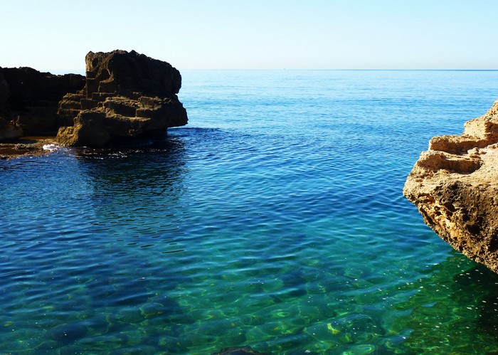 Rocky Coastline with Clear Blue Water in Spain