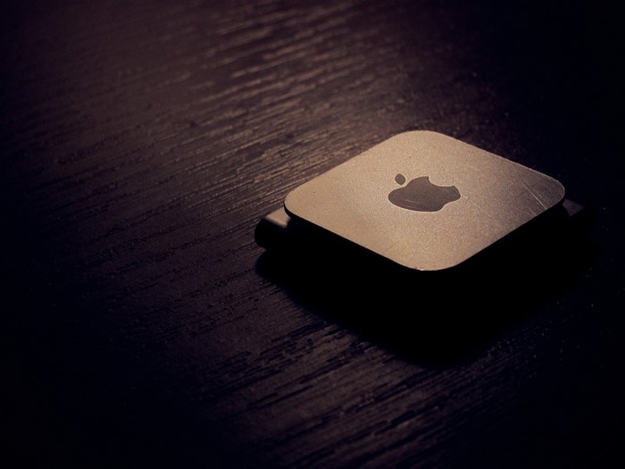 Apple logo on a dark wooden surface