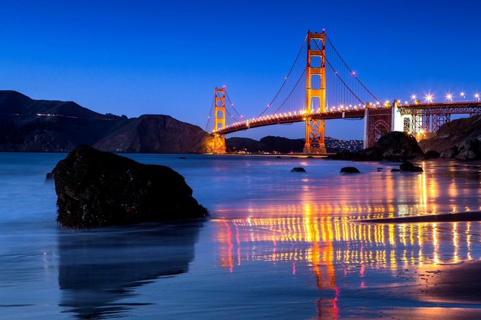 Golden Gate Bridge at night with reflections