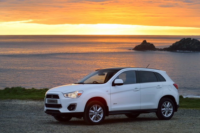 White Mitsubishi ASX parked by the sea at sunset