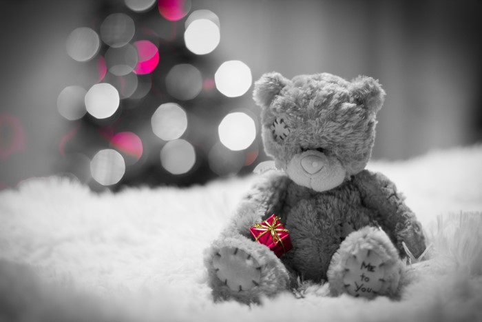 Teddy bear with gift and bokeh lights