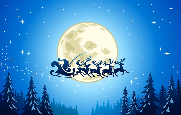 Santa Claus and reindeer flying in front of the moon