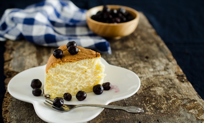 Slice of cheesecake with blueberries on a plate