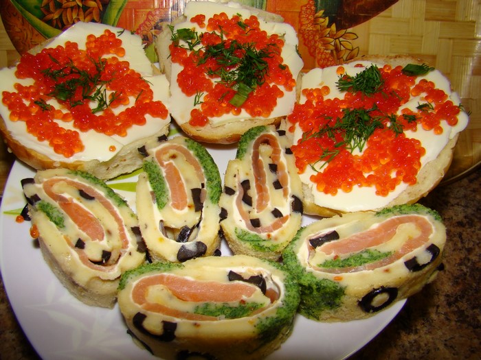Sandwiches with caviar and salmon rolls