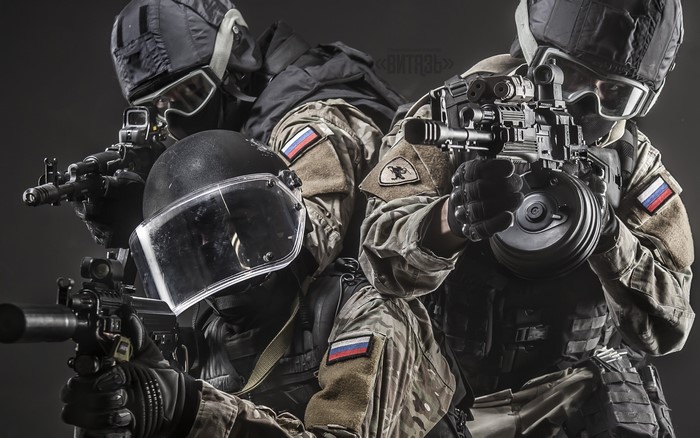 Three soldiers in tactical gear with assault rifles