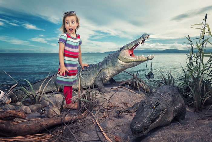Girl and crocodiles by the water