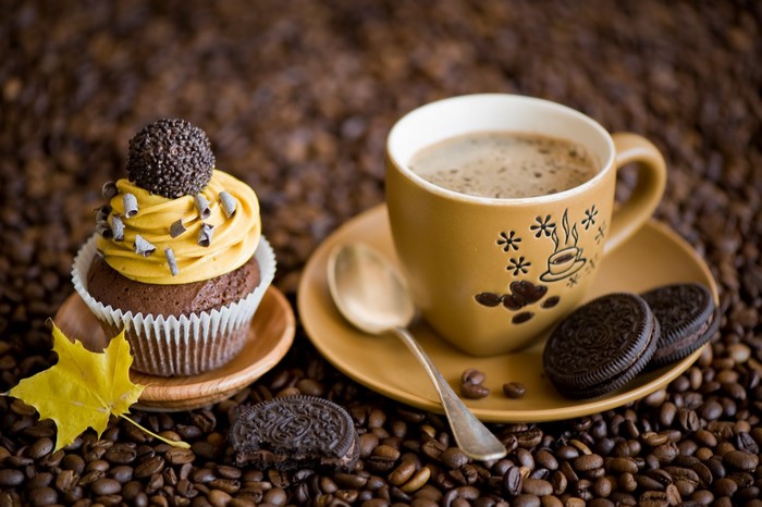 Cup of coffee with cupcake and cookies