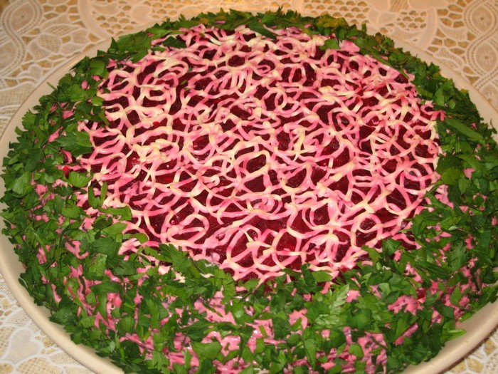 Beetroot salad decorated with mayonnaise and parsley