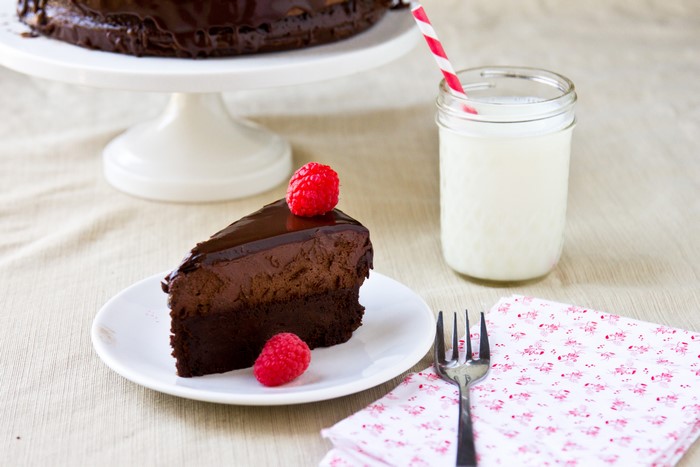 Chocolate cake slice with raspberries and milk