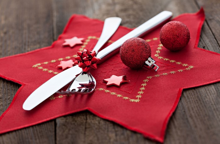 Christmas table setting with cutlery and ornaments