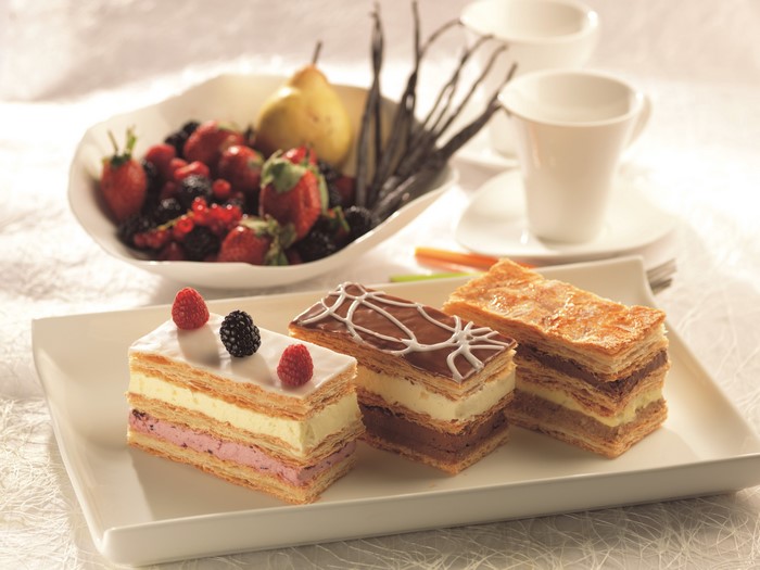 Mille-feuille pastries with berries and coffee cups