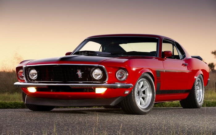 Red Ford Mustang Boss 302 parked on a road