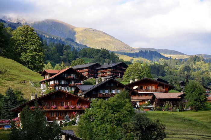 Traditional Swiss chalets in Grindelwald, Switzerland with mountains