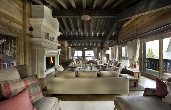 Luxury chalet living room with fireplace and mountain view