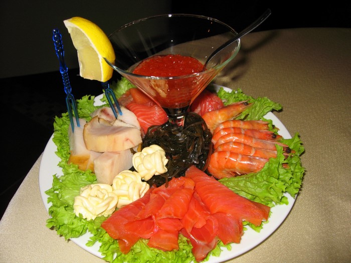 Seafood platter with shrimp, salmon, caviar, and lemon