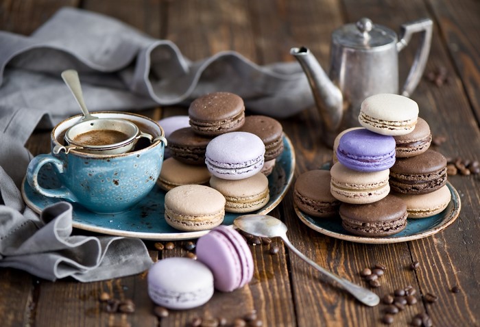 Coffee cup with macarons and teapot