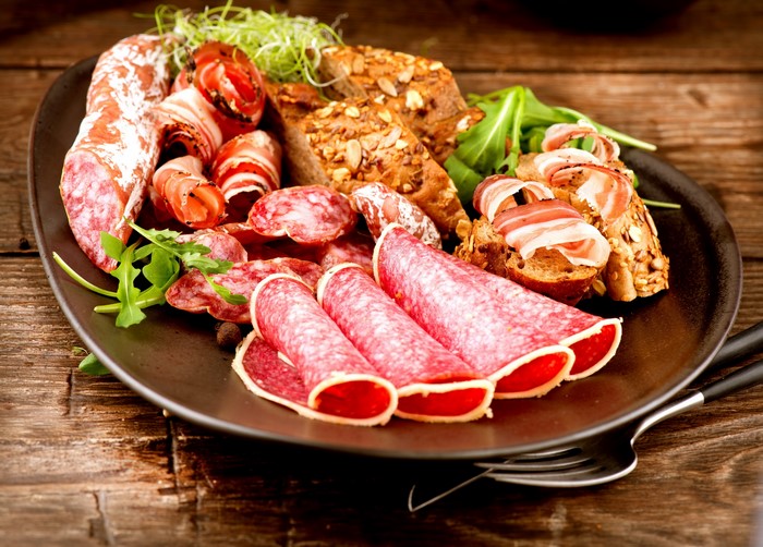 Charcuterie board with salami, ham, and bread