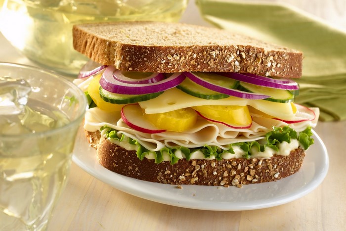 Turkey and cheese sandwich with vegetables on whole wheat bread